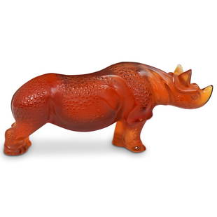 Lalique Crystal Amber Rhinoceros: DESCRIPTION: A large crystal lalique rhinoceros in an amber color. Traditionally marked Lalique France on the bottom of the foot. CIRCA: 1990s ORIGIN: France DIMENSIONS: H:4.5" L:10.5" D:3"