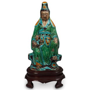 Ming Dynasty Shiwan Ware Guan Yin Sculpture: DESCRIPTION: A Ming dynasty Shiwan ware ceramic sculpture of Guan Yin (God Of Mercy) holding a child in a seated position finished in a green, yellow and turquoise blue glaze. Comes on a ROSE wood