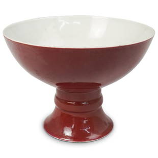 Antique Chinese Sang De Boeuf Bowl: DESCRIPTION: Antique Chinese oxblood glazed porcelain footed bowl with a white ground color interior. CIRCA: 19th ct ORIGIN: China DIMENSIONS: H:5.5" and 7.5" in diameter CONDITION: Great condition.