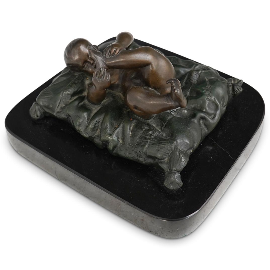 After Demetre Chiparus (Romanian 1886-1947) Bronze: DESCRIPTION: After Demetre Chiparus (Romanian 1886-1947) Bronze Sculpture depicting a newborn baby laying on a pillow. Signed " D.H. Chiparus. Finished on a black marble base. CIRCA:20th Century ORIGI