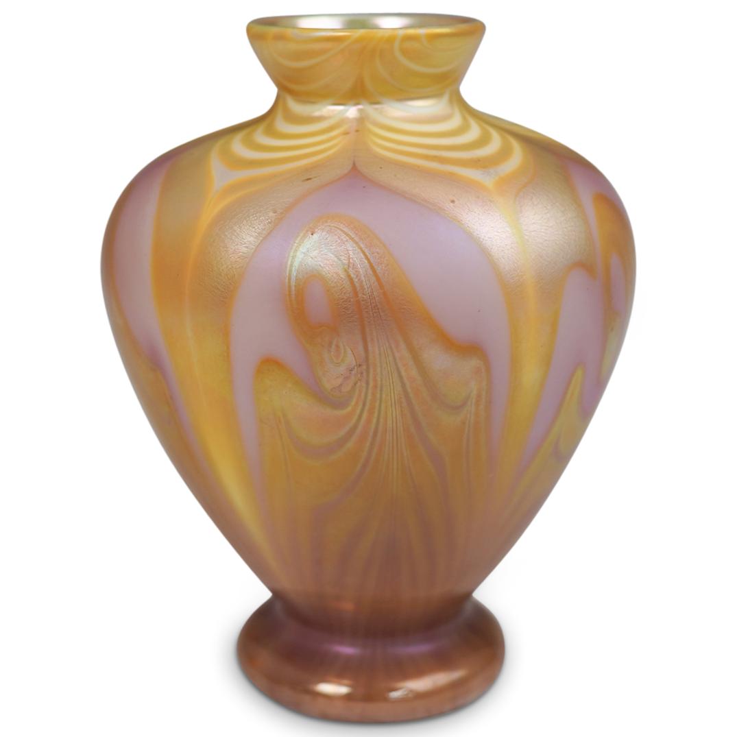 Orient and Flume Art Glass Vase: DESCRIPTION: Orient and Flume Art Glass Vase. Features a boboluse shape and layers of honey golden feathers pulled over pink base color. Finished with gilded iridescent threads drawn across the surfac