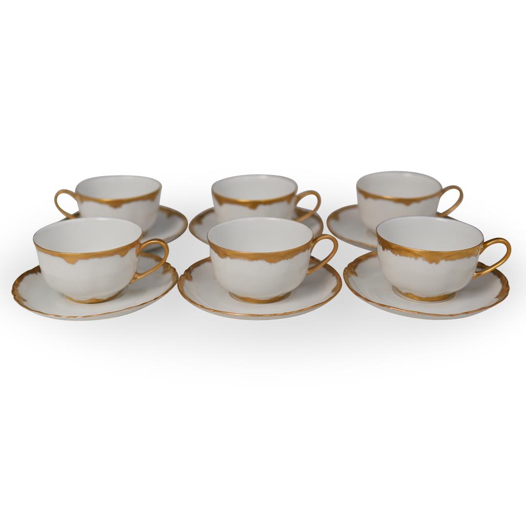 Hutschenreuther Porcelain Set: DESCRIPTION: A Hutschenreuther Selb porcelain tea set. Features glazed porcelain foundation with gilt lined rims and handles. Composed of (6) tea cups and (6) Saucers. Marked "Hutschenreuther Selb, Ba