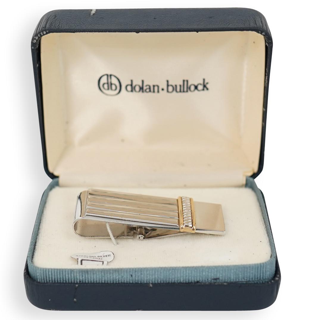 Dolan Bullock Silver and Gold Money Clip: DESCRIPTION: Dolan Bullock money clip composed of sterling silver and 14K gold. Marked "Sterling 14K". Also marked with the Dolan Bullock logo. CIRCA: 20th Century ORIGIN: USA DIMENSIONS: L 2.5" x W 1