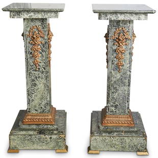 Dore Bronze & Green Marble Pedestals: DESCRIPTION: A pair of rectangular pedestals composed of green marble. Decorated with dore bronze wreaths and acanthus leaf accents. Finished with a tiered bases and square tops. CIRCA: 20th Ct