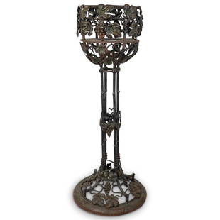 After Edgar Brandt Iron Jardiniere Stand: DESCRIPTION: After Edgar William Brandt (French, 1880-1960). Black patinated cast iron metal jardiniere features vineyard motif with interlacing grape vines leaves and fruit clusters ornaments. CIRCA: