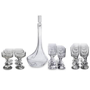 (25 Pc) Baccarat Crystal Stemware Set: DESCRIPTION: (25 Pc) A Baccarat clear crystal stemware set. Marked with Baccarat stamp underneath. Includes: (1) Crystal Decanter. (H: 16" x D: 7") (8) Martini Glasses. (H: 5.5" x D: 4") (4)