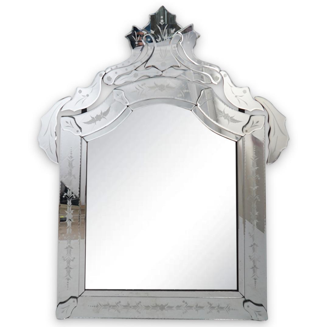Etched Venetian Glass Mirror: DESCRIPTION: An etched Venetian glass mirror. Features beveled mirror panels garnished with etched floral motifs and an overall scrolled design along the top panels. Reverse of mirror painted black wi