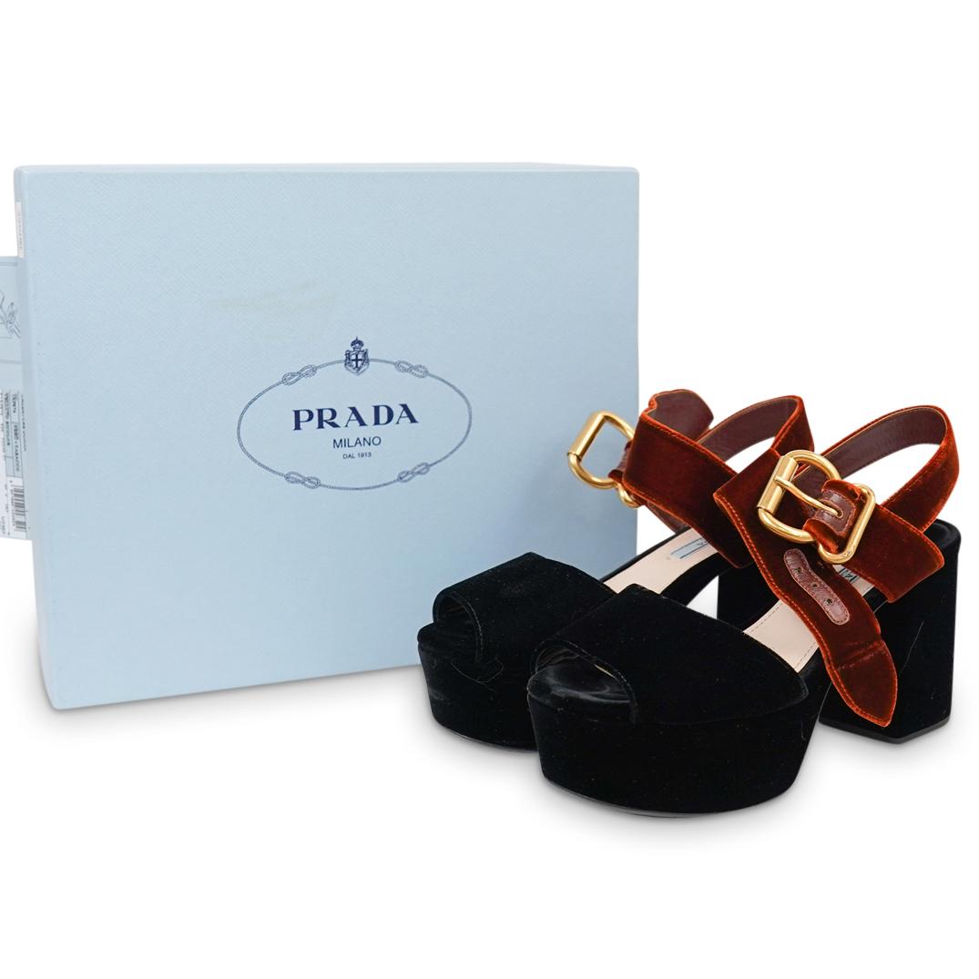 Prada Calzature Donna Platform Shoes: DESCRIPTION: A pair of Prada "Calzature Donna" platform shoes with black velvet foundations and tobacco brown velvet adjustable straps. Includes original dust bag and box. CIRCA: 20th Cent. ORIGIN: It