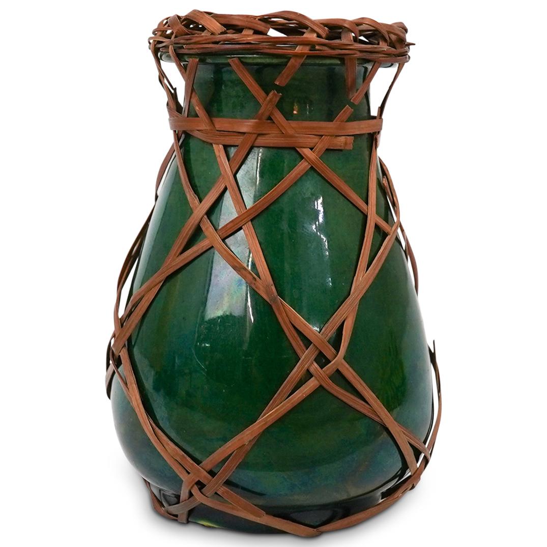 Japanese Awaji Rattan Pottery Vase: DESCRIPTION: An antique Japanese Awaji pottery vase with greenish brown glaze and rattan netting. Label attached underneath "4434" CIRCA: 19th - 20th Cent. ORIGIN: Japan DIMENSIONS: H: 3.75" x D: 2.5"