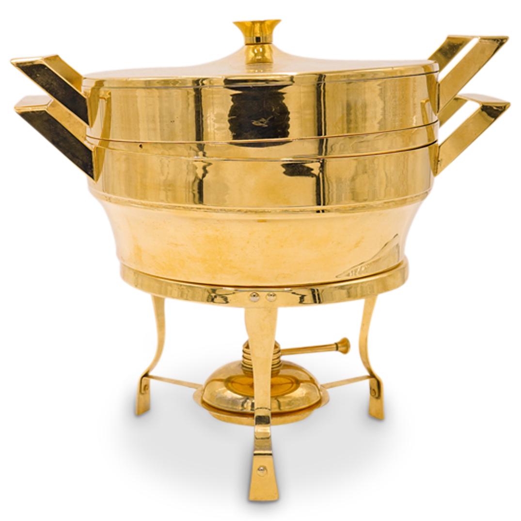 Mid Century Gold Chafing Dish: DESCRIPTION: A mid century gold toned metal chafing dish. Features a minimalist design with three removable food holding reservoirs and knob handled top lid. Finished with a warming lamp fitted stand 