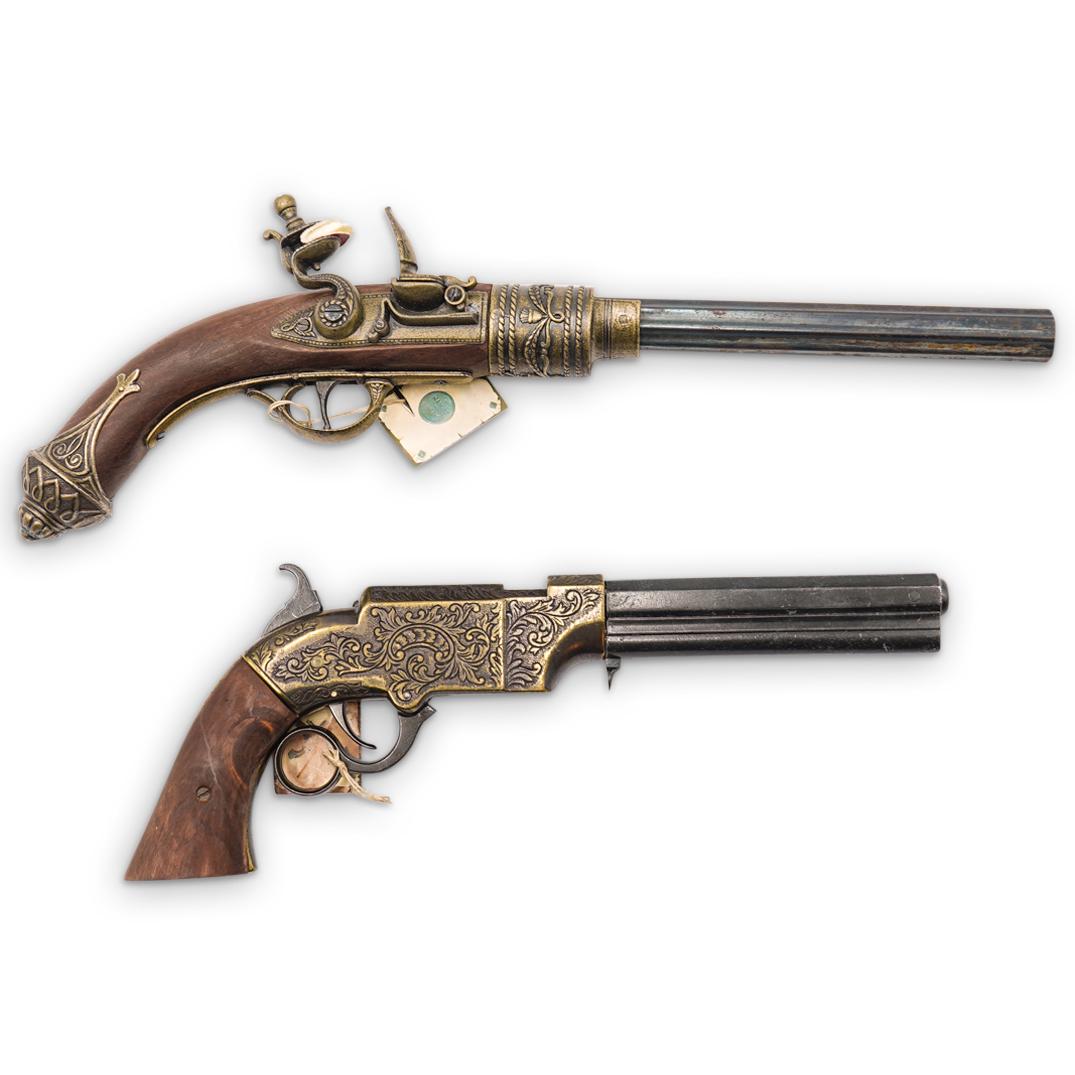 Pair of Decorative Replica Guns: DESCRIPTION: Pair of replica guns includes: (1) Decorative replica flintlock gun featuring ornate patterns. Marked "Made in Spain" (L 16.0" x W 2.0") (1) Decorative replica hammerlock gun featuring or