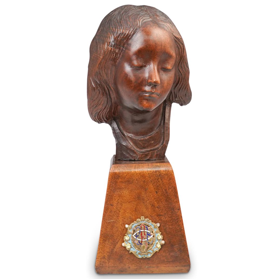 French Carved Madonna Wooden Bust: DESCRIPTION: A Carved Wooden Madonna Bust. Mounted on a wooden pedestal, with an etched enamel champleve RAB mark. CIRCA: 20th Century ORIGIN: France DIMENSIONS: H: 14" W: 5 1/2" L: 6" CONDITION: Grea