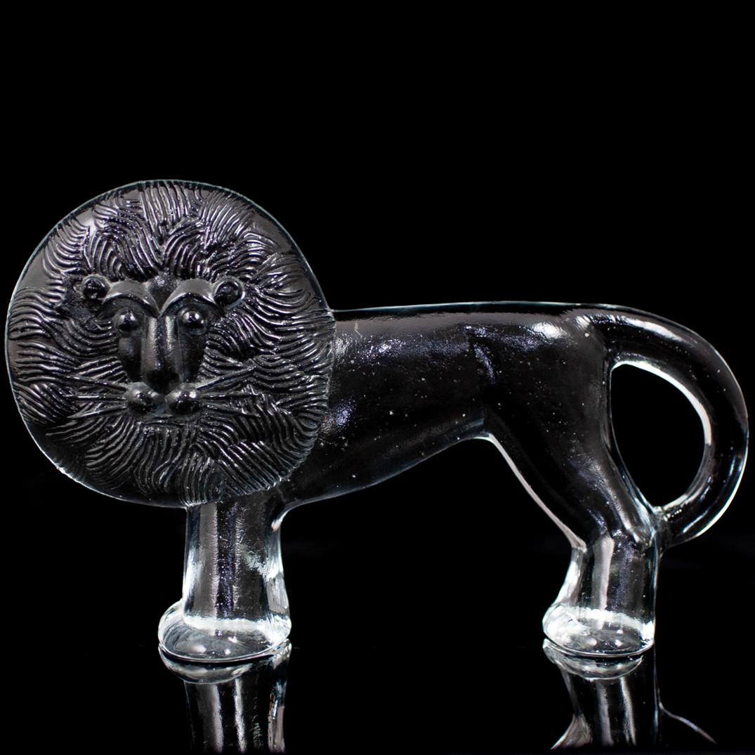 Crystal Lion Paperweight: DESCRIPTION: A full lead crystal paperweight features in a two dimensional lion. CIRCA: 20th Ct. ORIGIN: USA DIMENSIONS: H: 3 5/8" L: 5 1/2" W: 1 1/2" CONDITION: Great condition. See lot description f