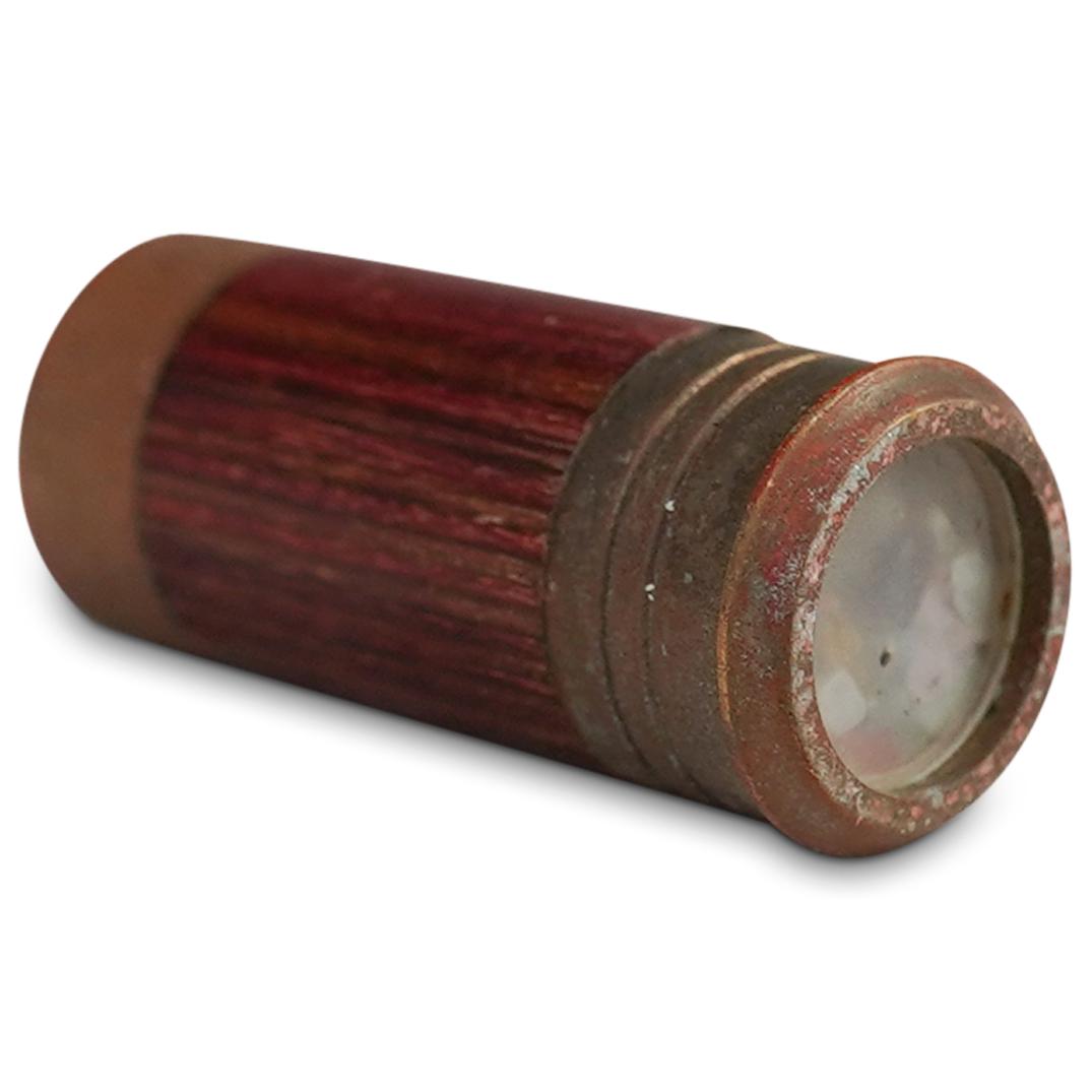 Miniature Brass Kaleidoscope: DESCRIPTION: A miniature brass and wood kaleidoscope. CIRCA: 20th Cent. ORIGIN: USA DIMENSIONS: H: 2.25" x D: 0.75" CONDITION: Fair condition, tarnish to brass. See lot description for details on item
