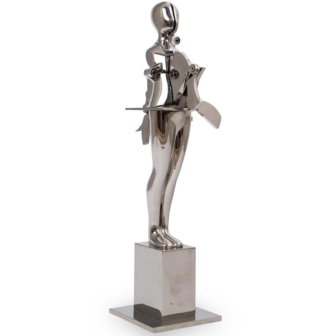 Ernest Trova (American, 1927-2009) "Radical Cut Figure": DESCRIPTION:A sculpture by American surrealist Ernest Trova titled "Radicul Cut" composed of stainless steel. An edition of 8 pieces and 2 A.P. Engraved with Trova mark "E. TROVA 3/8 ,1979" . Comes wi