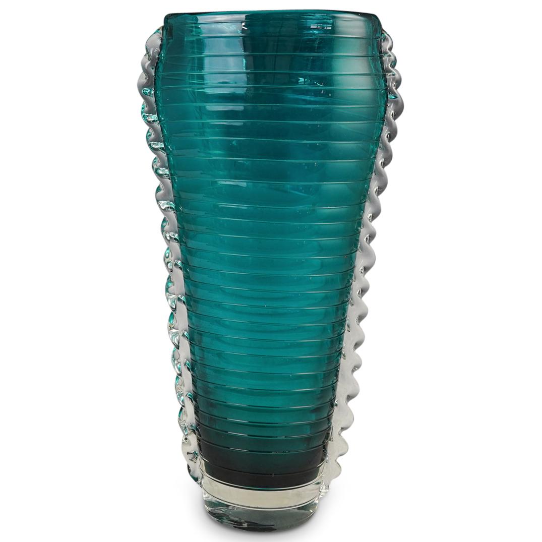 Murano Art Glass Vase: DESCRIPTION: Murano Green Glass Vase with a wavy design consisting of exterior horizontal cuts and decorated on the sides by a clear glass ruffle accent.CIRCA: 20th CenturyORIGIN: ItalyDIMENSIONS: H: 