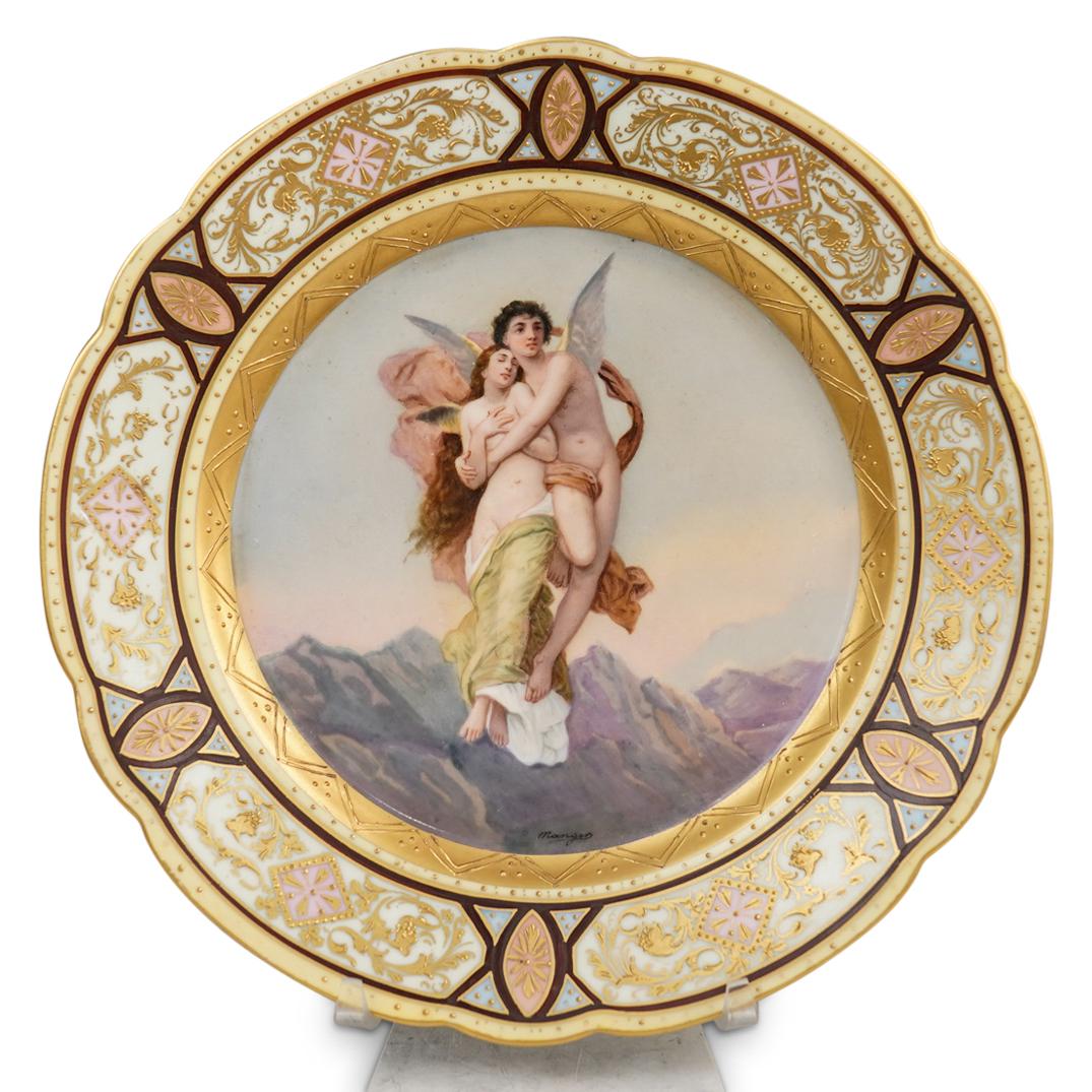 French Porcelain Cupid Plate: DESCRIPTION: Sevres Porcelain Plate with hand painted portrait depicting a beautiful romantic scene of Cupid holding a female lady. There is an ornate design with raised gold decoration on the rim fea