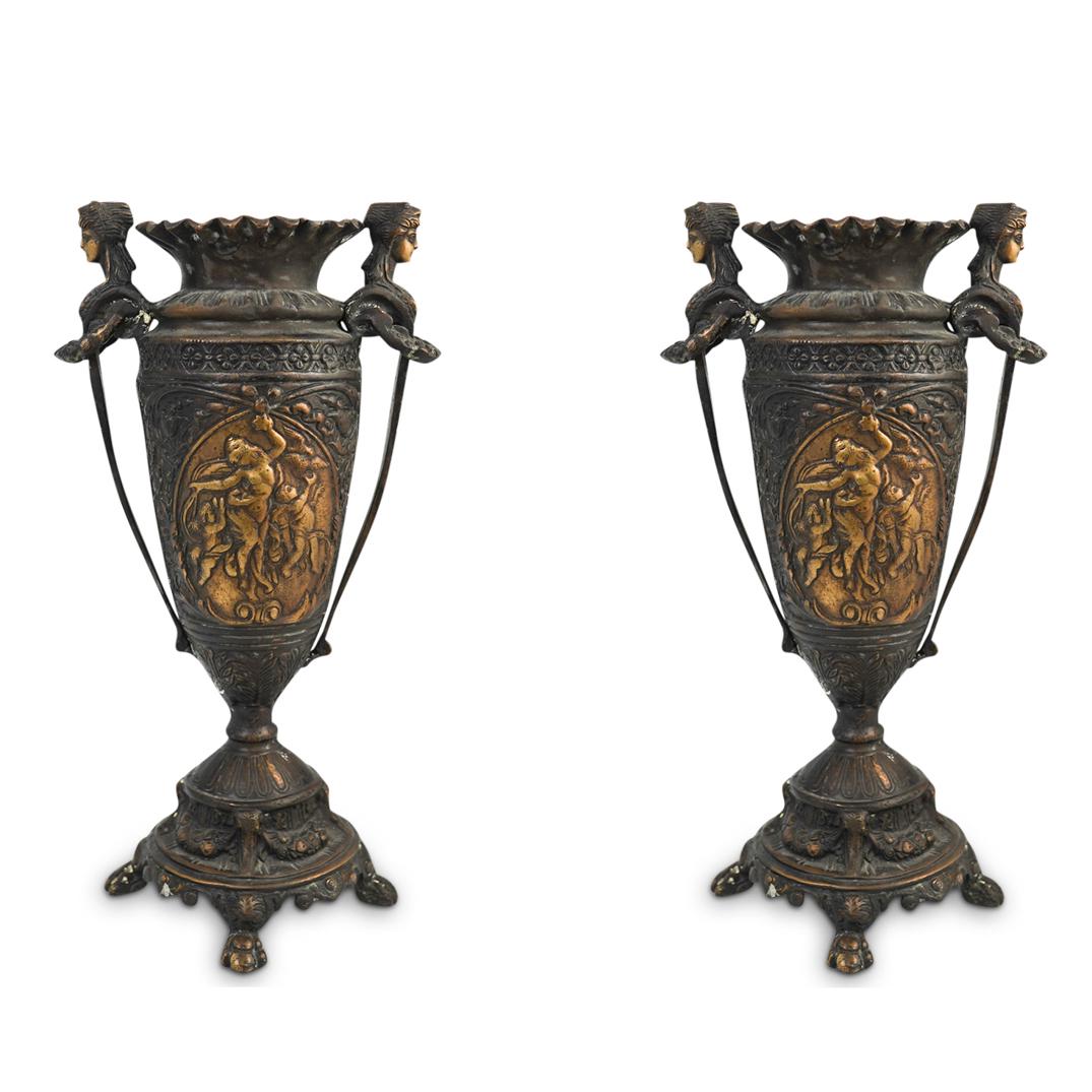 Pair Of Antique French Bronze Vases: DESCRIPTION: (2 pcs) Pair of exquisite french antique bronze urn vases beautifully carved depicting a nude female and cherubs theme on each side. Handles are carved with a female bust design and garla