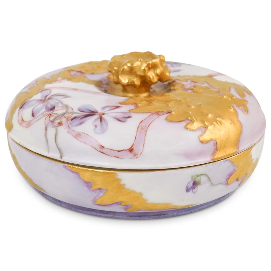 J.P Limoges Porcelain Lidded Bowl: DESCRIPTION: An Antique Limoges porcelain lidded bowl decorated along the body and top with floral decorations and gilt accents, completed with a gilt finial. Stamped along the bottom "JP Limoges". CI