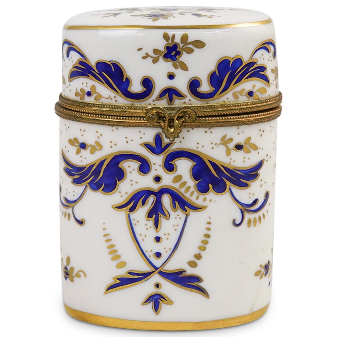 Limoges Porcelain Cylindrical Box: DESCRIPTION: A Limoges porcelain box features hand painted cobalt floral designs, accented with brassware. Marked along the underside "Limoges France" CIRCA: 20th Cent. ORIGIN: France DIMENSIONS: H: 3