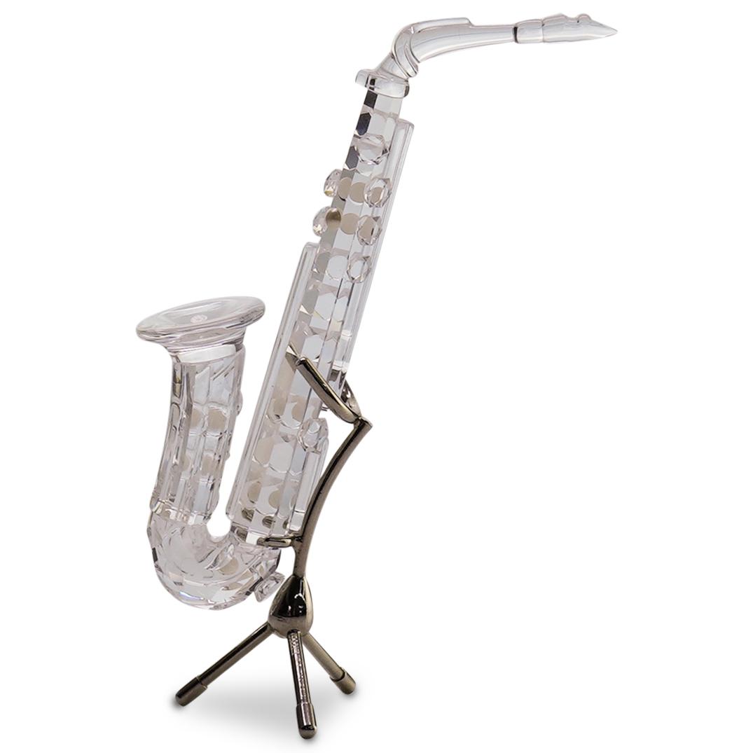 Swarovski " Saxophone " Crystal Figurine: DESCRIPTION: Swarovski Saxophone (with stand) Crystal Figurine part of Swarovski Melodies Collection. Swarovski code number 211728. Introduced 1992/ Retired 1998. Designer : Martin Zendron. Laser etch