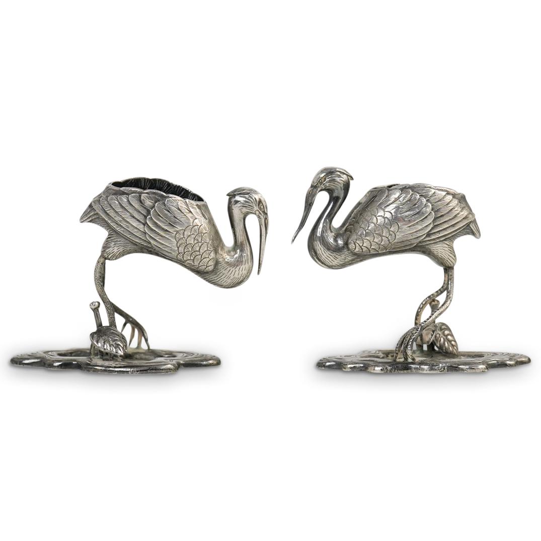 Pair Of Sterling Silver Crane Salt Cellars: DESCRIPTION: A Pair of salt cellars in the form of cranes, composed of sterling silver completed with realistic details. Marked along the underside "Sterling". Total Weight: 65 Grams CIRCA: 20th Cent.