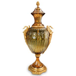 Imperial Style Amber Crystal & Dore Bronze Urn: DESCRIPTION: An Empire style cut crystal urn with amber and citrine colorations. Features naturalistic dore bronze swan motif handles, finished with a gilt acorn finial and ornate scrolling base.