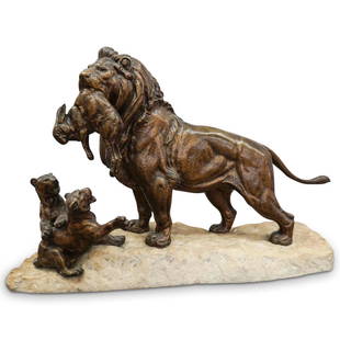 Signed Lion Bronze and Stone Statue: DESCRIPTION: A bronze lion statue features a male lion bringing a hare to his cubs, the bronze figures are affixed to a rugged stone base. Signed along the base. CIRCA: Early-Mid 20th Cent. ORIGIN: