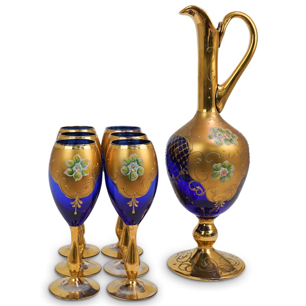 (7 Pc) Bohemian Blue Glass Pitcher Set: DESCRIPTION: (7 Pc) Blue Glass Wine Pitcher with six glasses set in cobalt blue glass with gold gilt paint and hand painted bouquet of flowers decoration. Set includes:(1) Cobalt Blue Glass Decanter w