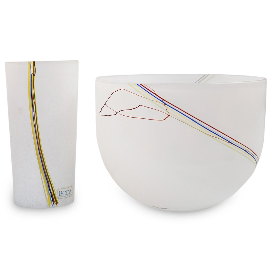 (2 Pc) Kosta Boda Art Glass Set: DESCRIPTION: (2 Pc) Kosta Boda Art White Glass Set. Set includes:(1) Rounded Vase signed by Artist Bertil Vallien. White frosted glass with clear interior and decorated with artistic strokes of colorf