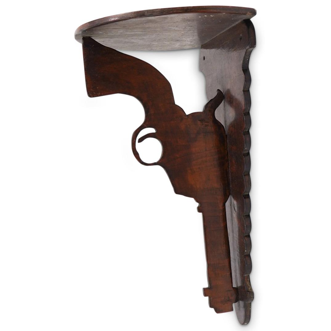 Antique Folk Art Carved Pistol Corner Shelf: DESCRIPTION: Antique Folk Art Carved and Painted Pistol Trade Sign Corner Shelf. CIRCA: Early 20th CenturyORIGIN: USADIMENSIONS: H: 11 3/8" W: 7 3/8" D: 5 3/4"CONDITION: Great condition. See lot descr