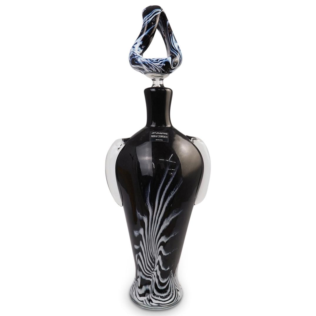 Romanian Art Glass Vase by Mihai Topescu: DESCRIPTION: Hand crafted blackout art glass bottle by romanian master glass maker Mihai Topescu, consisting of a vase with art glass topper in black color glass with white organic pattern accent moti