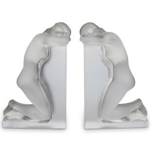 Lalique "Reverie" Crystal Bookends: DESCRIPTION: A pair of Lalique crystal "Reverie" bookends. Features posed frosted crystal nude women. Signed "Lalique R, France" CIRCA: 20th Cent. ORIGIN: France DIMENSIONS: H: 9.25" x W: 3.25" x L: