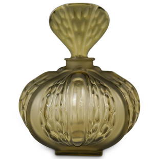 Lalique "Mirabel" Glass Vanity Bottle: DESCRIPTION: A Lalique "Mirabel" smokey glass vanity bottle. Features a bulb shaped body with frosted accents and rounded triangular stopper. Signed "Lalique, France" underneath. CIRCA: 20th Cent.