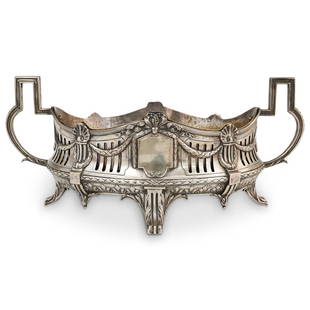 Neoclassical Sterling Silver Center Bowl: DESCRIPTION: A Neoclassical Sterling Silver center bowl decorated with draping vine and ribbon motifs, further reticulated along the frame. Features two ornate handles, further decorated along the