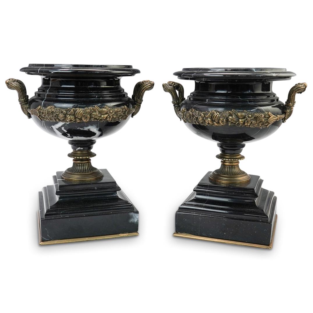 Pair of Italian Marble and Bronze Urns: DESCRIPTION: ( 2 Pc) Italian Antique Black Marble and Bronze Urn Set. This is a pair of italian black and white variegated marble urns with gilt bronze decorative accents. The neoclassical bodies of t