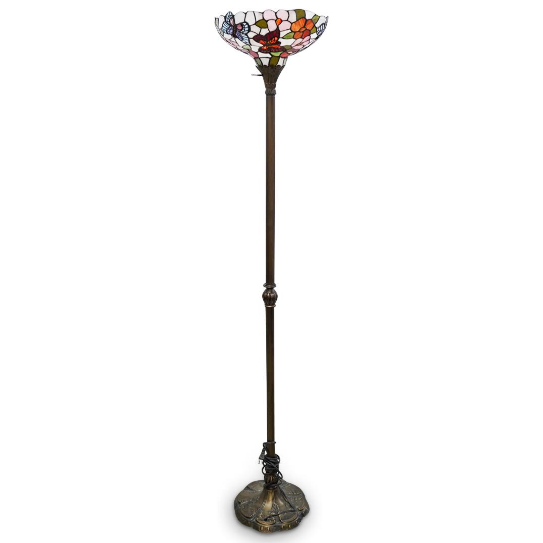 Tiffany Style Floor Lamp: DESCRIPTION: A vintage Tiffany style floor lamp with copper toned metal foundation and mounted floral and butterfly stained glass shade. Designed with a turn key power switch and ornate detailed base.