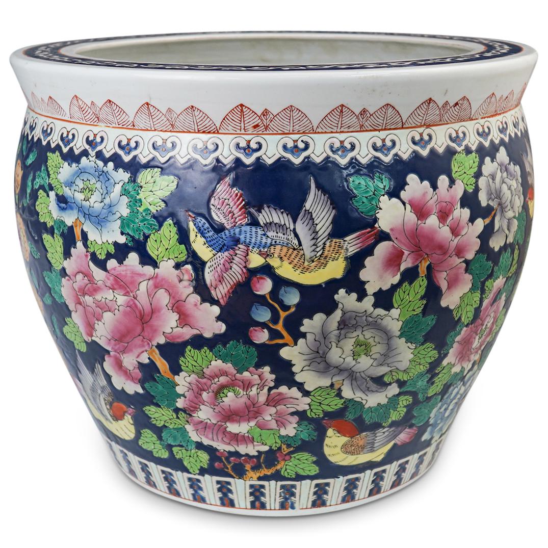 Chinese Porcelain Jardiniere Fish Bowl: DESCRIPTION: Chinese Porcelain Jardiniere Fish Bowl featuring hand painted depictions of blooming flowers, birds, and butterflies over a rich midnight blue background. Finished with a hand painted dec