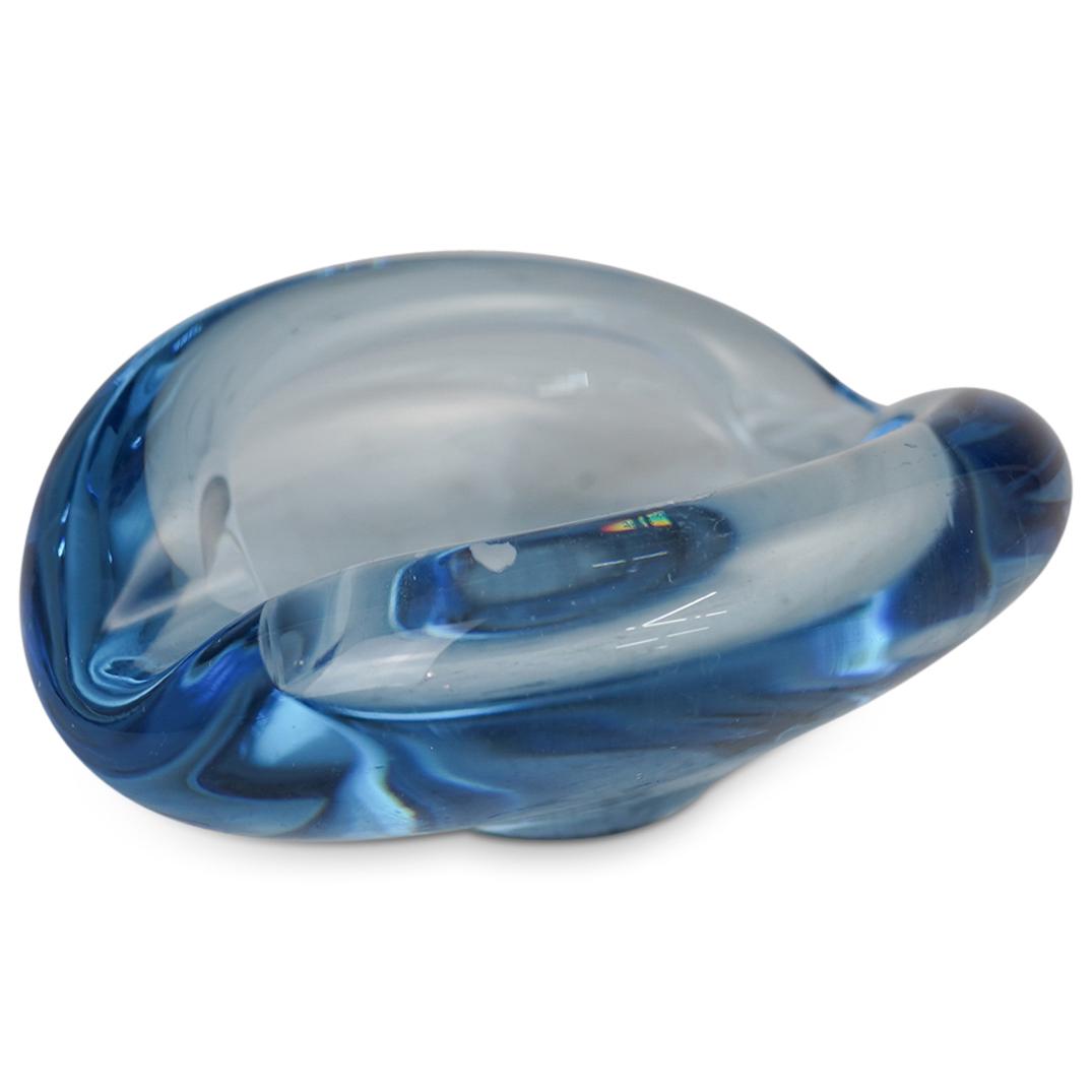 Murano Glass Ashtray: DESCRIPTION: A Murano glass ashtray with thick blue glass foundation and flared rims. Signed illegibly undenieht. CIRCA: 20th Cent. ORIGIN: Italy DIMENSIONS: H: 3" x D: 6" CONDITION: Great condition. 
