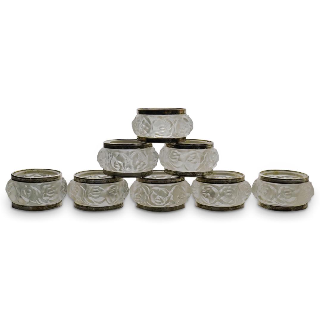 (8 Pc) Lalique Style Crystal Napkin Rings: DESCRIPTION: A set of eight Lalique style Napkin rings decorated with floral motifs and silver lining. CIRCA: 20th Cent. ORIGIN: Continental DIMENSIONS: Diameter: 2.25" CONDITION: Great condition. See