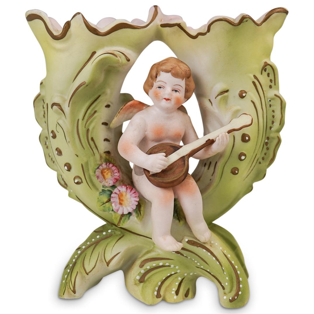 Japanese Ardalt Bisque Porcelain Cherub Double Vase: DESCRIPTION: Japanese Ardalt Bisque Porcelain Cherub Double Vase. Hand Painted Bisque porcelain with two separated vases design depicting a central figure of a cherub playing the harp. CIRCA: 1950's. 
