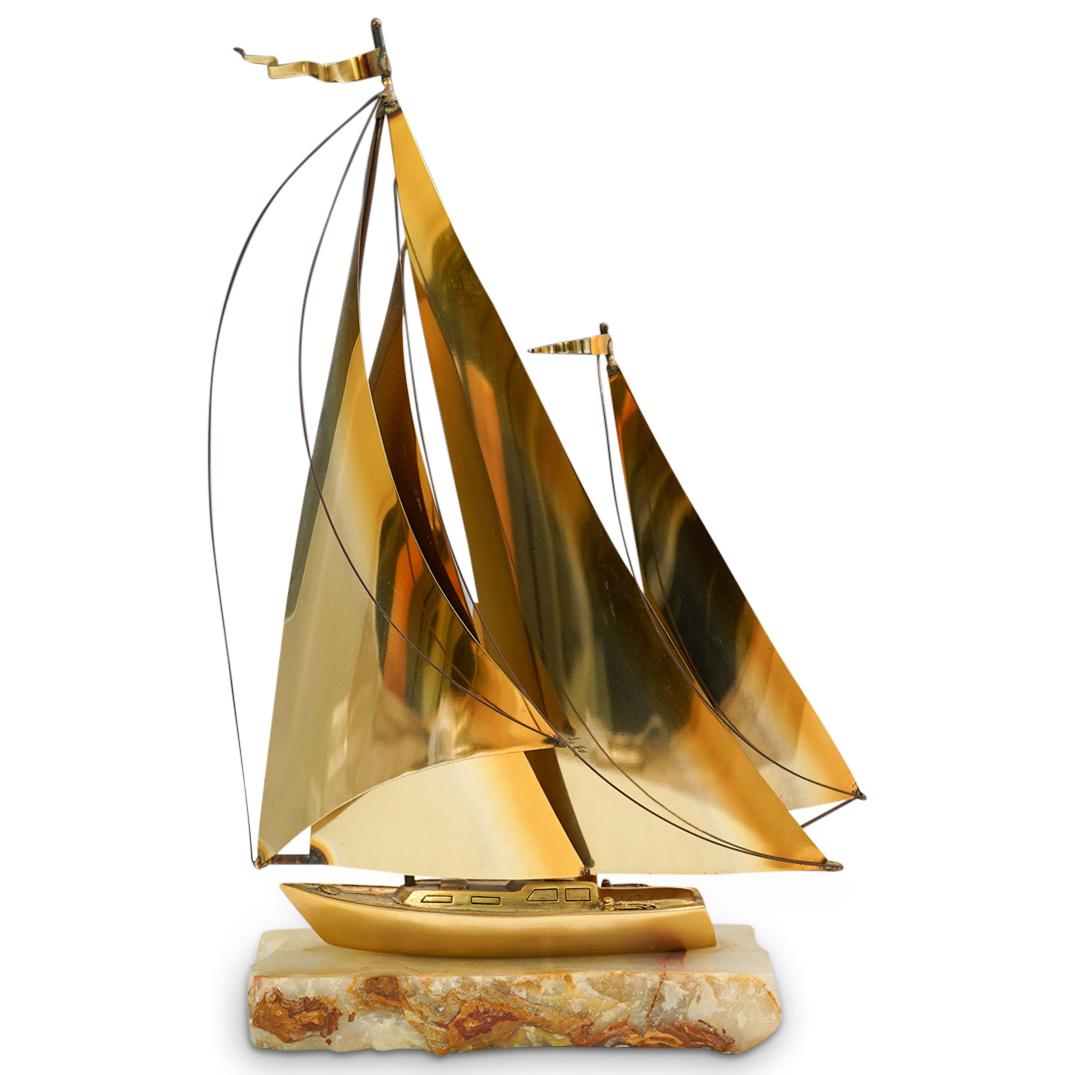 Don Demott Brass and Onyx "Golden Ketch" Sailboat: DESCRIPTION: Brass Sailboat on an onyx stone base sculpture entitled "Golden Ketch". This is an explendid nautical sculpture made of brass depicting a three masted sailing ship with four sails. With c