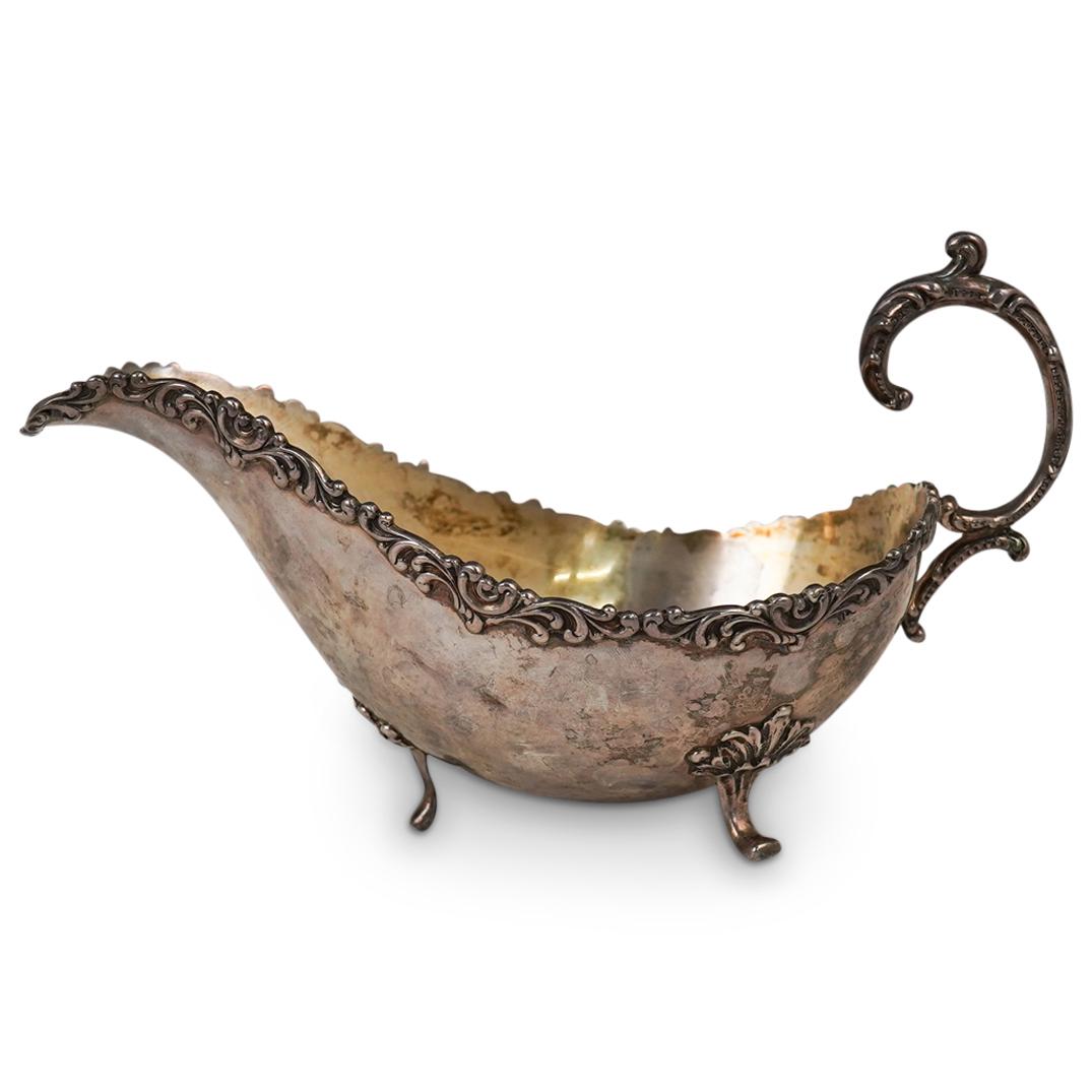 Antique Sterling Silver Gravy Boat: DESCRIPTION: (1) Sterling silver gravy boat decorated along the rim and handle with ornate patterns, stamped along the underside "Sterling". Total Weight: 170 Grams CIRCA: Late 19th to Early 20th Cent