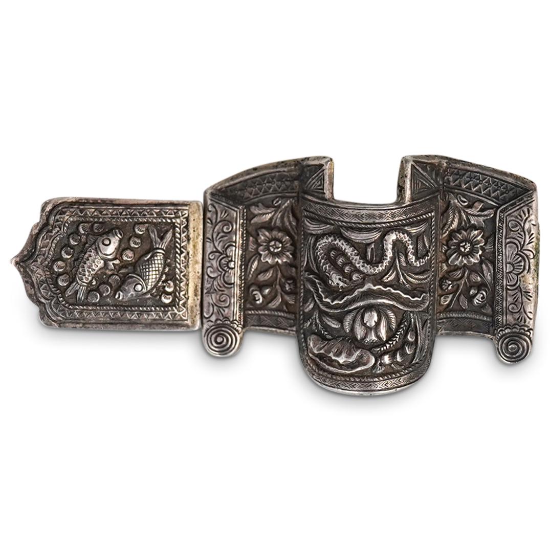 Antique Chinese Silver Belt buckle: DESCRIPTION: A 19th century Chinese belt buckle composed of silver with intricately engraved floral, snake, and fish motifs. CIRCA: 19th Cent. ORIGIN: China DIMENSIONS: (H: 1.5" x L: 3.5") Total Weigh