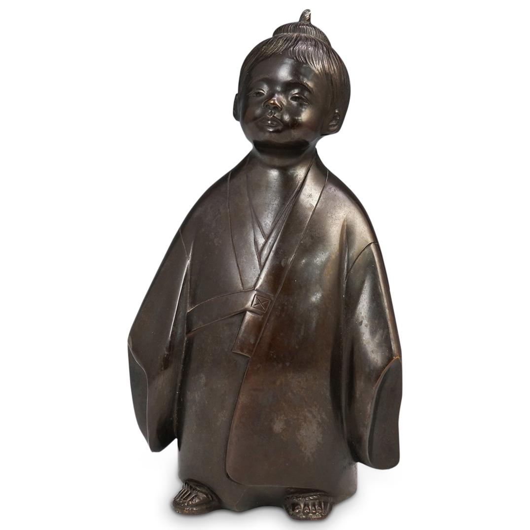 Japanese Okimono Bronze Figure: DESCRIPTION: A Japanese Meiji Okimono bronze depicting a young child with knotted hair, wearing a flowing kimono. Marked with engraved Japanese character markings. CIRCA: Late 19th-Early 20th Ct. ORIG