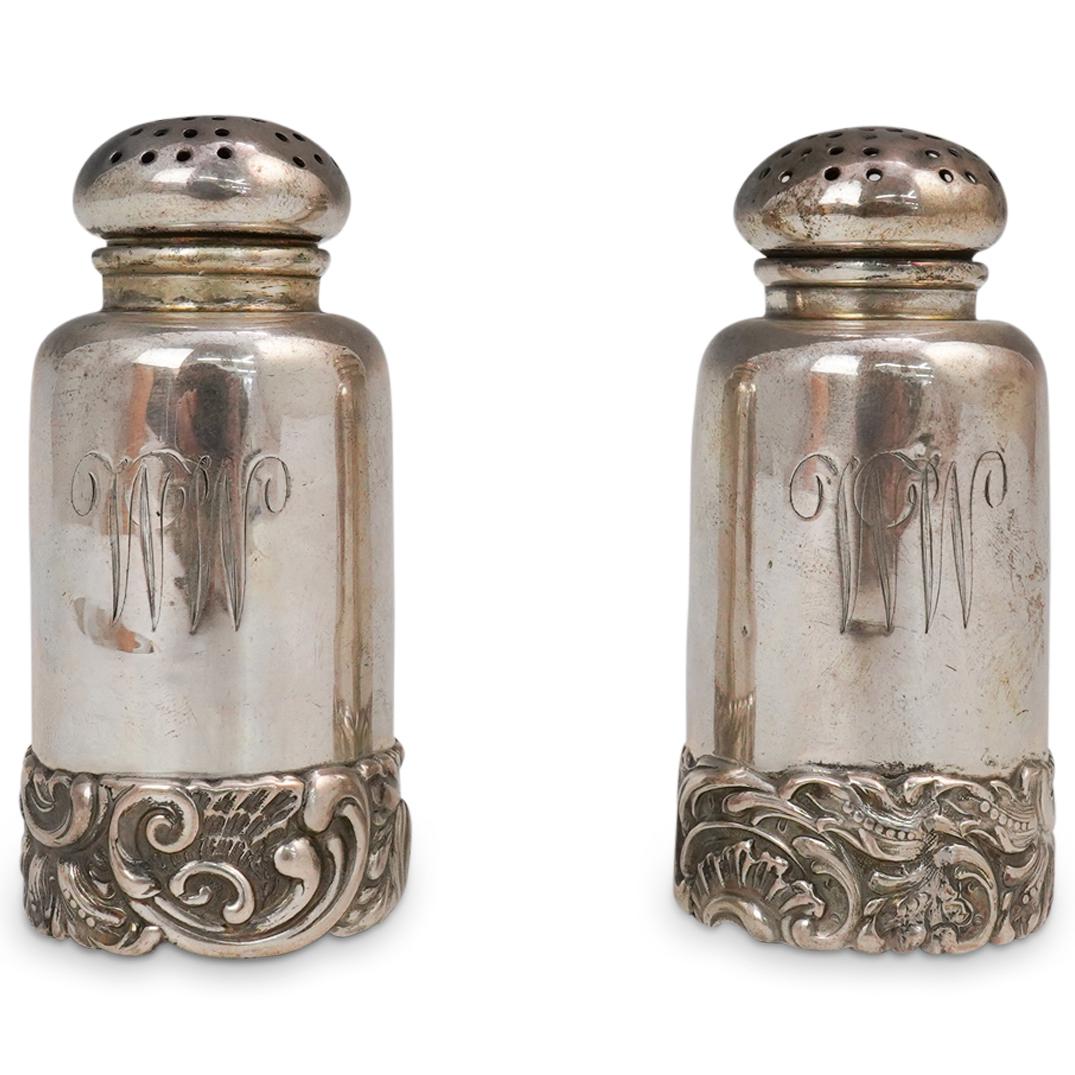 Shiebler Sterling Salt & Pepper Shakers: DESCRIPTION: "Shiebler" sterling silver salt and pepper shakers with ornate scrolling detailed bases. Hallmarked: "Sterling" CIRCA: 20th Cent. ORIGIN: USA DIMENSIONS: H: 3.25" x D: 1.5" Total Weight: 