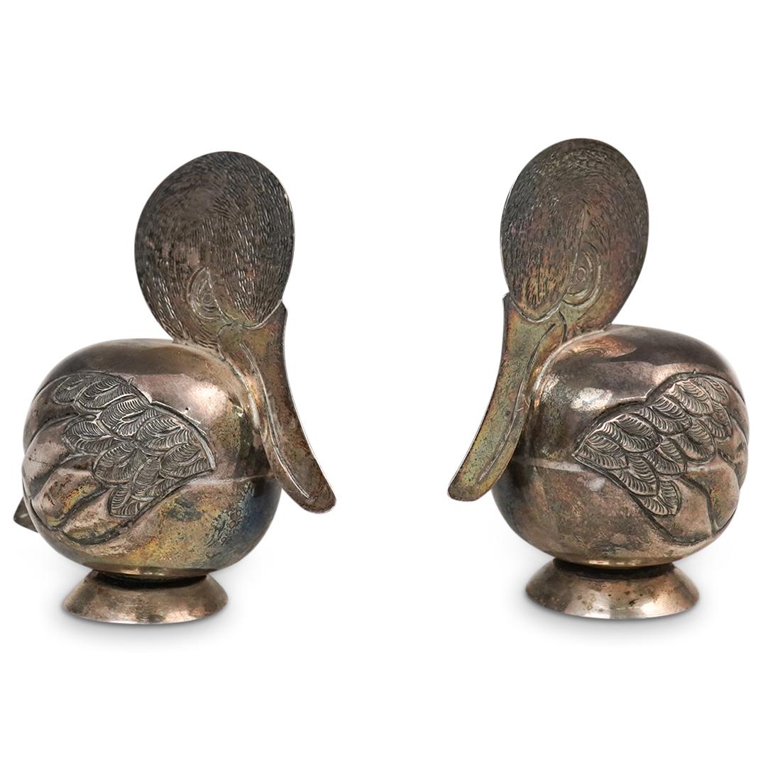 .900 Silver Pelican Salt & Pepper Shakers: DESCRIPTION: .900 silver salt and pepper shakers with pelican motif decorations. Hallmarked: "900" CIRCA: 20th cent. ORIGIN: Continental DIMENSIONS: H: 2.75" x D: 3" (44 Grams) CONDITION: Great condit