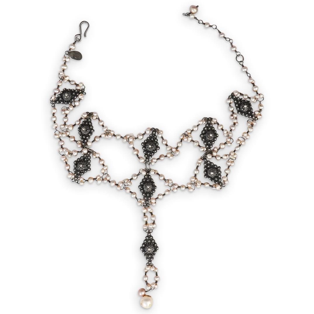 "Yvone Christa" Sterling Pearl Necklace: DESCRIPTION: A designer "Yvone Christa" sterling silver and seed pearl necklace. Marked: Yvone Christa, 925" CIRCA: 20th cent. ORIGIN: Continental DIMENSIONS: L: 15.5" x W: 5" Total Weight: 50 Grams C