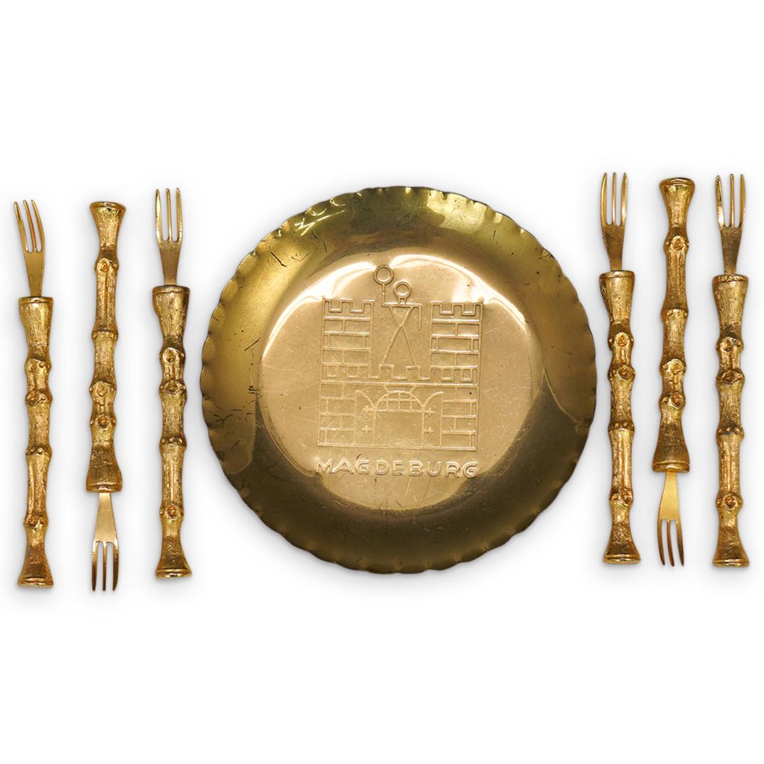 (7 Pc) Cocktail Forks & Plate: DESCRIPTION: (7 Pc) Six Cocktail forks with bamboo shaped handle in gold metalware and brass small plate with Magdeburg engraving decoration. CIRCA: 20th Century. DIMENSIONS: Fork is L: 3 3/4". Plate 