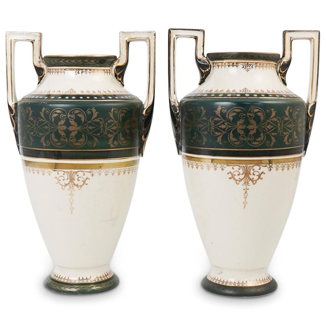 Pair Of Boch Freres Porcelain Vases: DESCRIPTION: Pair of Boch Freres porcelain vases features in a egg white ground color, decorated with green banners and ornate gilt trims, flanked on either side with handles. Marked along the undersi